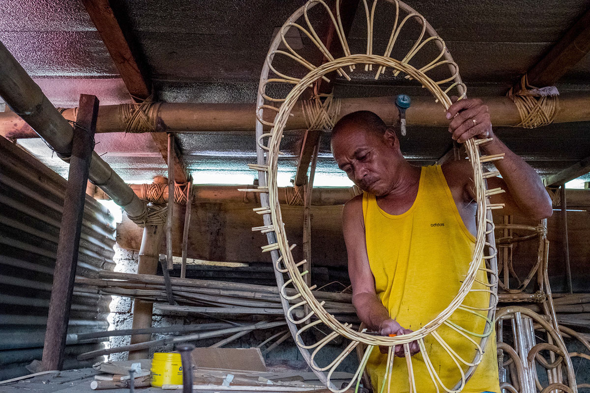 July 2017. Owner, Idevlino Dagot, making rattan furniture at Dagot Rattan Crafts and Furniture. Puerto Princesa, Palawan, Philippines. Photograph by Jason Houston for USAID