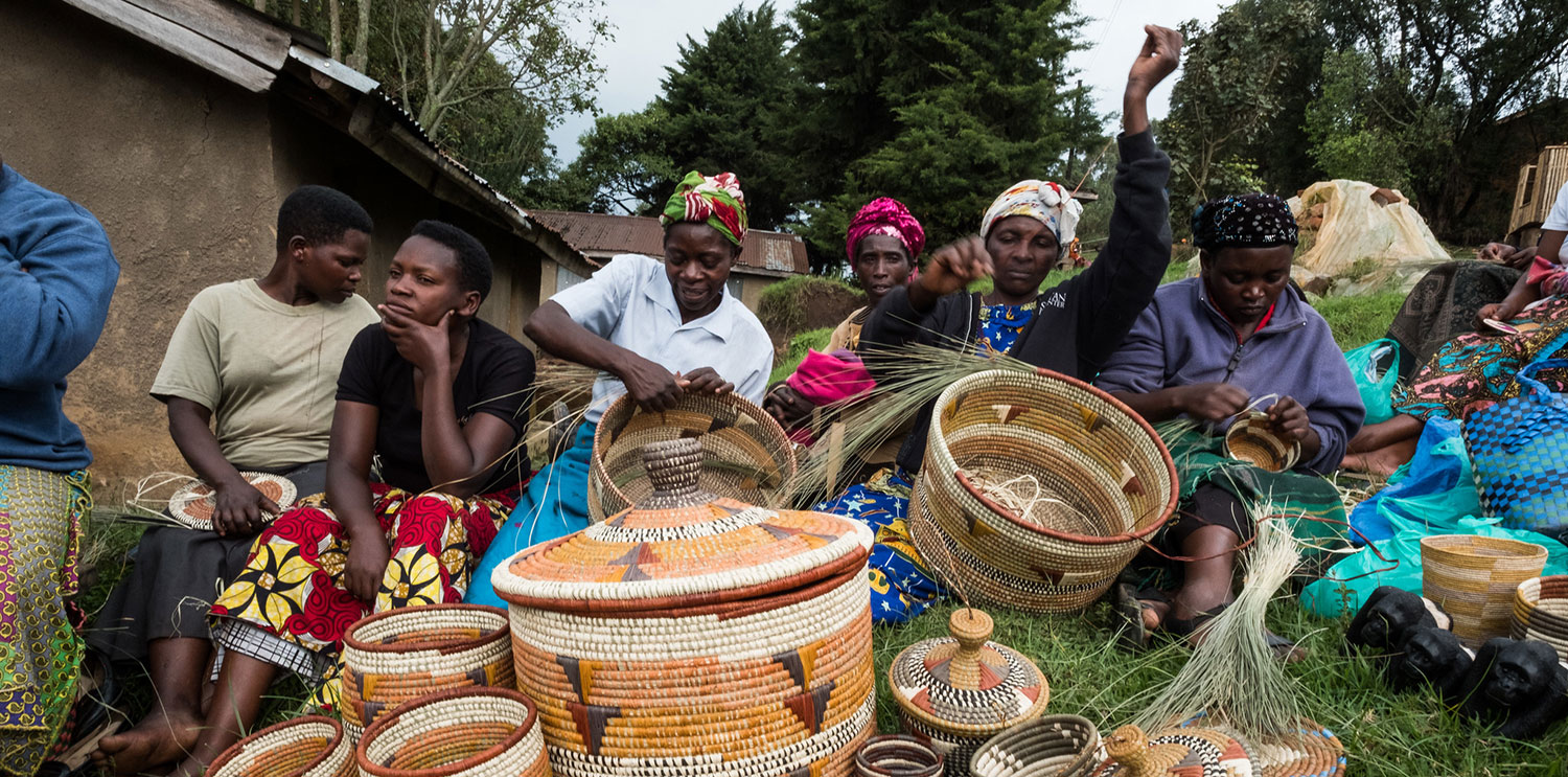 September 2017. Women with a local artisans group are learning to weave traditional baskets as handicrafts for sale to tourists. The organization promotes close collaboration among the members, and they often help each other with small loans and technical skills. Unfortunately, they were evicted from their previous workshop and showroom and are now looking for another location. Nkuringo, Uganda. Photograph by Jason Houston for USAID
