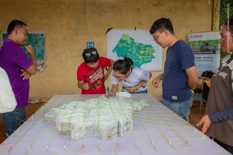 Community members work on the topographical map