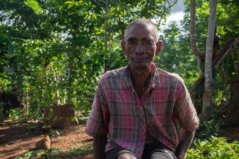 Portrait of Emile Gatson, a cacao farmer, in forest in Madagascar. Photo credit: Fenohenintsoa Jerry Andrianaivoarivony for USAID/Madagascar